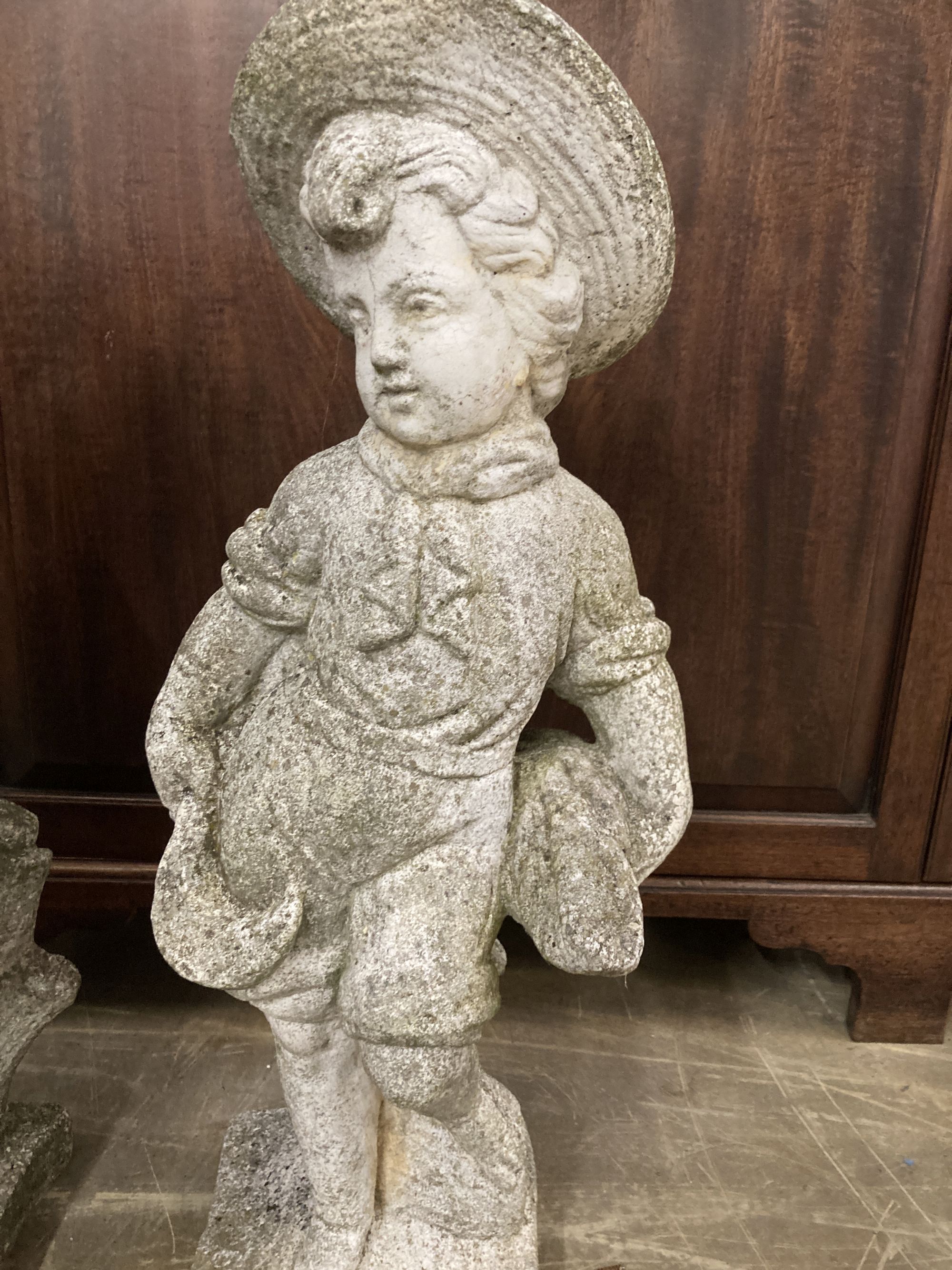 A pair of reconstituted stone garden ornaments, boys with wheatsheaves, larger 87cm high